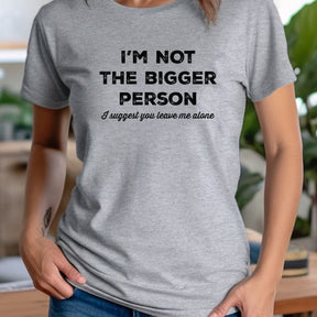 Person wearing a gray t-shirt with humorous text design.