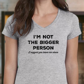 Person wearing a gray t-shirt with humorous text design.