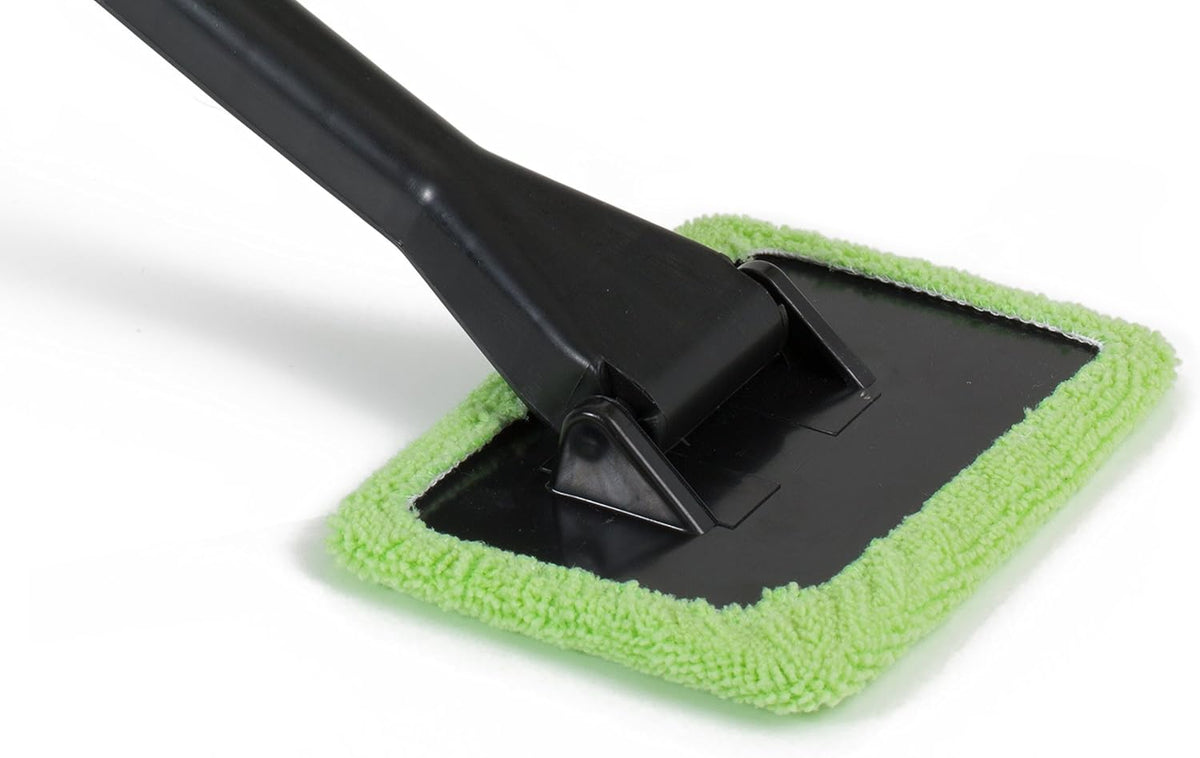 Close-up view of the pivoting head of a window cleaner featuring a black plastic base and a green microfiber cloth around the edges, highlighting the texture of the cloth.