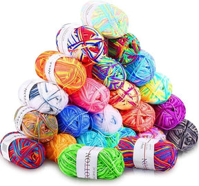 A colorful array of 23 acrylic yarn skeins in various shades, including bright oranges, pinks, blues, and greens, stacked in a pyramid shape. Each skein features a label with care instructions and brand name visible.