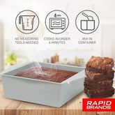 Square, gray microwave brownie maker displaying warm, freshly baked brownies with steam rising from the surface, accompanied by stacked brownies on the side.
