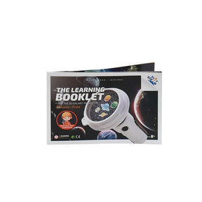 The learning booklet for the PlaySTEM 3D Galaxy Projector features a colorful design with illustrations of planets against a starry background, along with text indicating it's "glasses-free." It showcases a playful character encouraging users to draw their own projections.