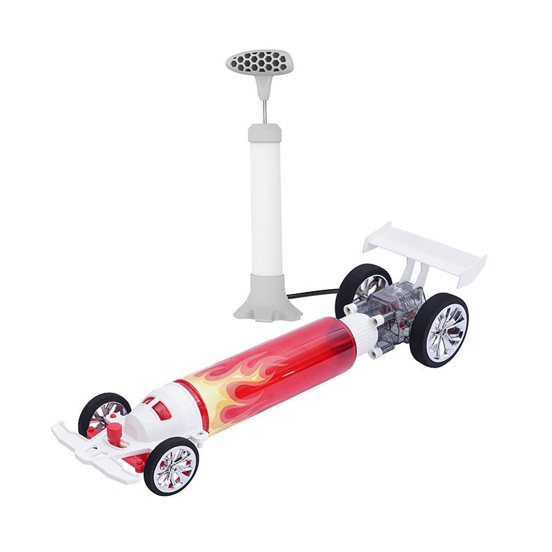 The Atmospheric Inferno Turbo Racer features a sleek red design with flame graphics, large wheels, and a detailed engine visible through a transparent casing. A pump with a grey handle is included, connected by a cord to the car's body.