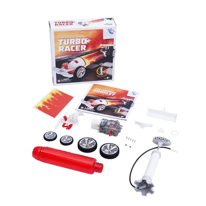 Contents include a red turbo booster, four wheels, a learning booklet, and various components for assembly, all arranged around the colorful packaging featuring flames and the product name.