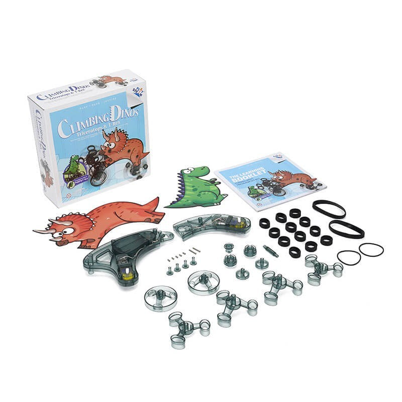 A variety of transparent and colorful components from the PlaySTEAM Climbing Triceratops & Hopping T-Rex Robotics Toy set, including dinosaur cutouts, assembly parts, screws, and rubber bands, arranged next to the game box and instruction booklet.
