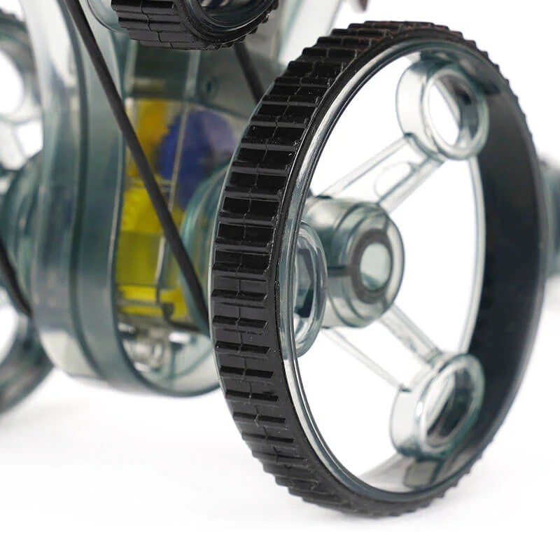 Close-up of the black rubber tread on the transparent wheels of the robotics toy, showcasing the intricate design and clear components of the vehicle.