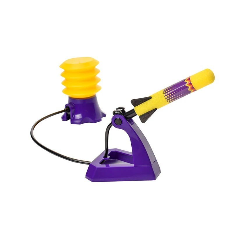 Bright yellow and purple air rocket launcher set featuring a bulb-shaped air pump and a foam rocket with a colorful design. The rocket is positioned on a purple launcher base ready for action.