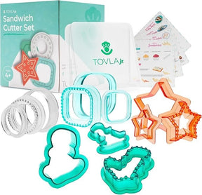 Colorful sandwich cutters in fun shapes, including stars, a ghost, and a snowman, along with a container and recipe cards, presented in a vibrant packaging. The set is designed for creating playful, themed sandwiches suitable for children.