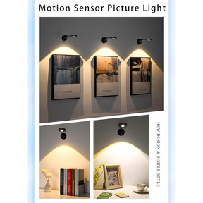 Three black wireless motion sensor picture spotlights are shown illuminating artwork on a wall, demonstrating their effect. Additional images feature one spotlight highlighting books on a shelf and another spotlight illuminating a framed photo and a vase on a table.