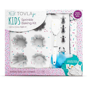 The kit includes a white spatula, multiple piping tips, and a silicone mold shaped like flowers, all set against a colorful background with sprinkles. The packaging features a playful design with the brand name "Tovla Jr" prominently displayed.