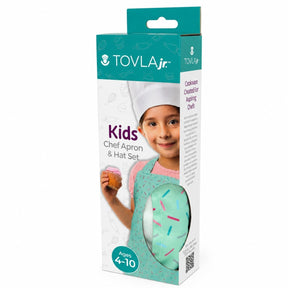 The packaging features a smiling child wearing a white chef hat and a mint green apron adorned with colorful sprinkles, holding a cupcake in her left hand. The set is designed for kids aged 4-10 and emphasizes fun in the kitchen.