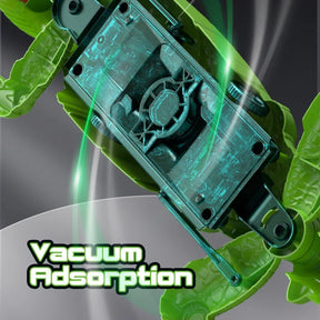 The underside of the remote control lizard toy features a transparent section revealing its vacuum mechanism, with a prominent text label stating "Vacuum Adsorption" in bold, stylized letters. The vibrant green body and limbs of the lizard are visible, showcasing its design.