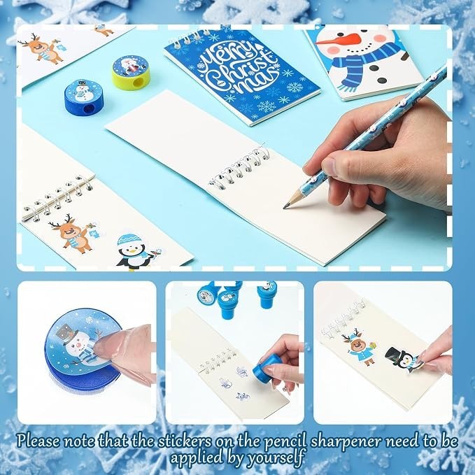 A hand writes in a notepad featuring colorful winter-themed characters, alongside a festive notebook, pencil sharpener, and decorative stickers. The scene is set on a light blue background with snowflake accents.
