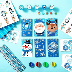 A vibrant collection of winter-themed stationery items, including colorful miniature notebooks featuring festive characters like Santa and a snowman, along with stickers, washi tape adorned with snowmen, and colorful pencil sharpeners in red, green, and yellow.
