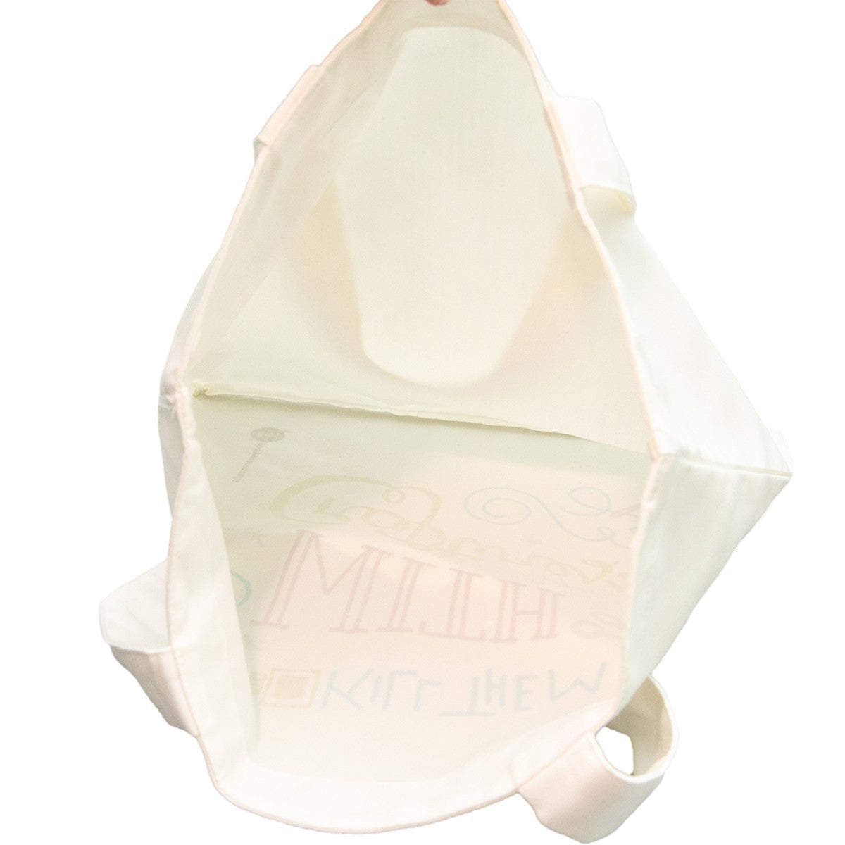 The canvas tote bag is shown from the side, featuring a cream color and colorful decorative text with various craft-related symbols. The bag has two sturdy handles for easy carrying.