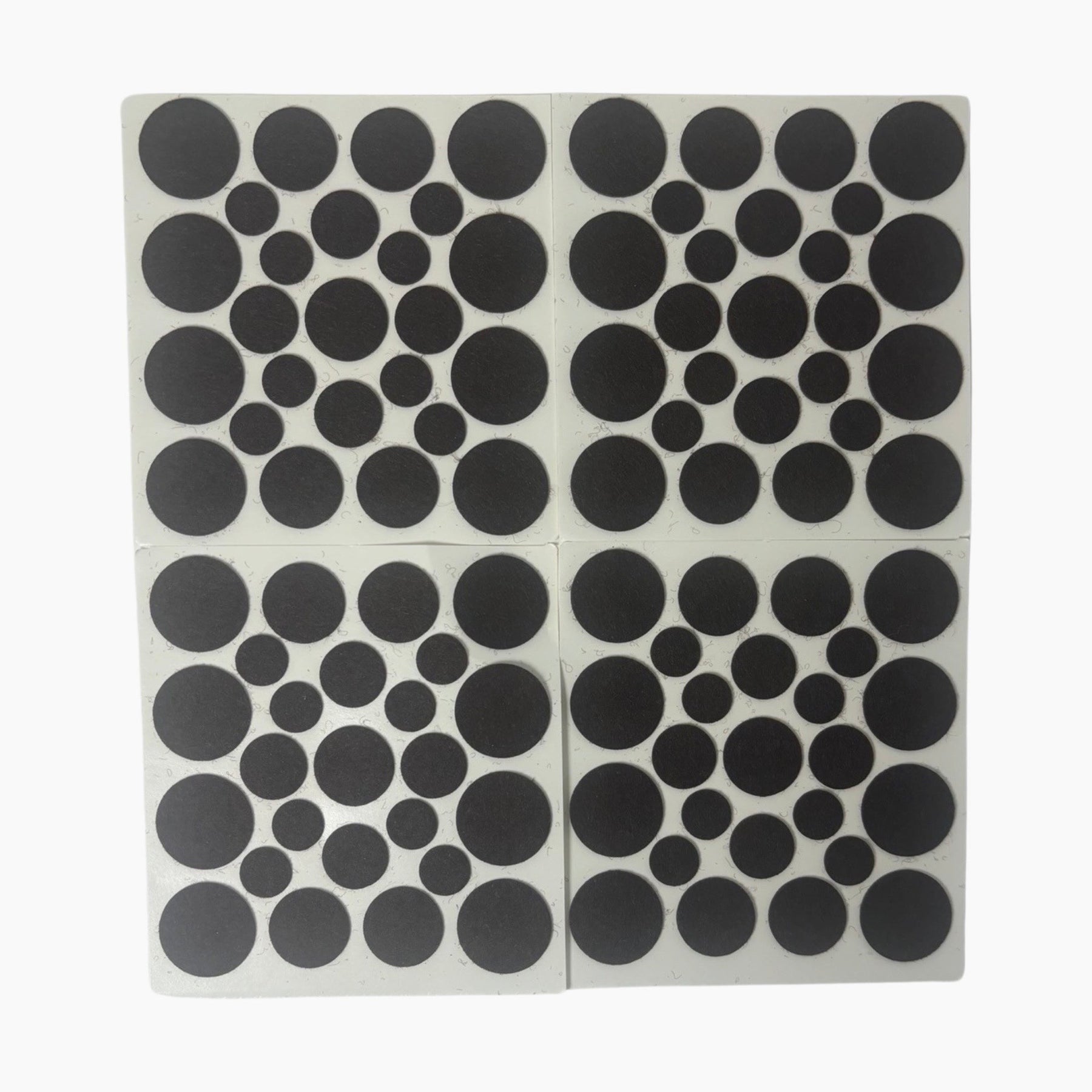 Collection of black felt pads in various circular sizes against a white background, showing the uniform texture and design ideal for surface protection.