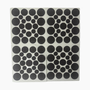 Collection of black felt pads in various circular sizes against a white background, showing the uniform texture and design ideal for surface protection.