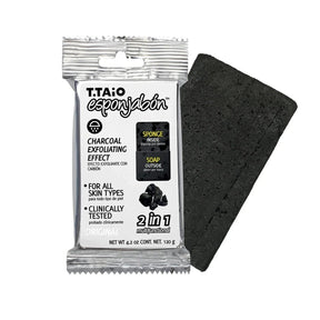 Black rectangular sponge and soap hybrid with a textured surface, packaged in a clear wrapper featuring labels for "Sponge Inside," "Soap Outside," and "Charcoal Exfoliating Effect." The product is prominently marked "2 in 1" and is intended for all skin types.