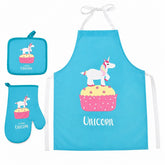 Bright turquoise apron, oven mitt, and pot holder set featuring a playful unicorn on a cupcake graphic. The apron includes ties at the neck and waist and has "Unicorn" printed in a fun font.