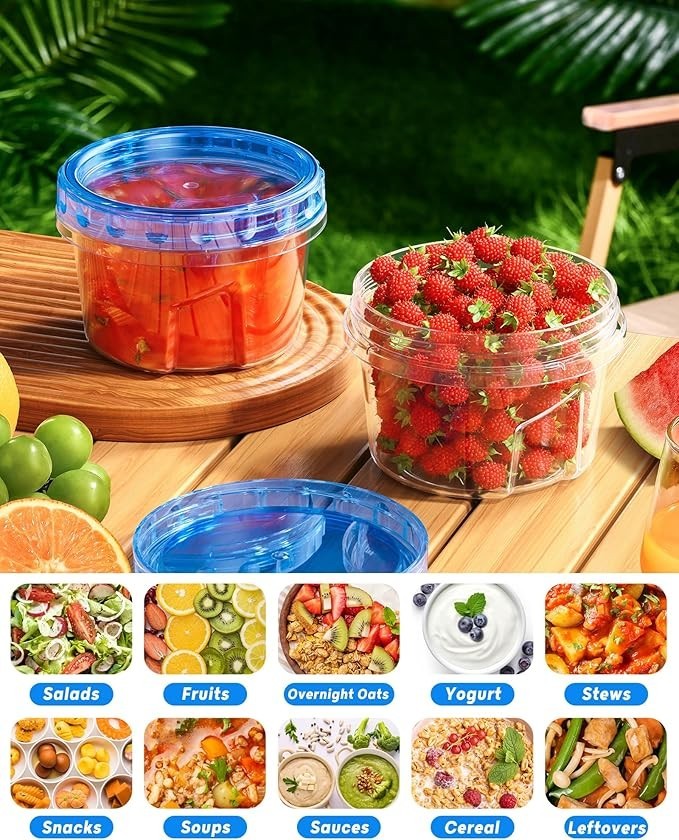 Two transparent plastic storage containers with blue twist lids, one filled with sliced red peppers and the other filled with fresh strawberries, are placed on a wooden surface amidst a backdrop of greenery.