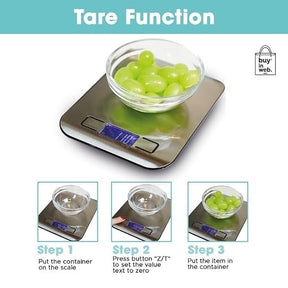 The digital food scale features a stainless steel platform with a bowl containing green grapes placed on it, illustrating the tare function. Instructions for using the tare function are shown in three steps below the scale.