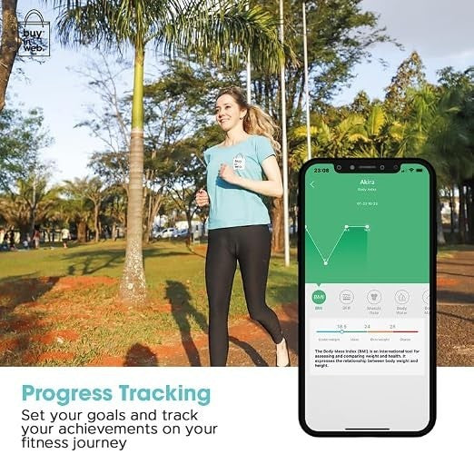 A woman jogging outdoors in a park, wearing a light blue t-shirt and black leggings, while holding a smartphone displaying fitness tracking information on the screen.