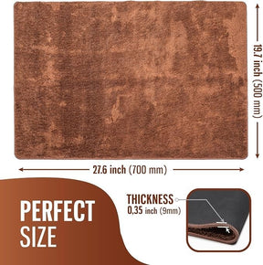 The brown doormat features a plush, absorbent texture with measurements displayed: 27.6 inches wide and 19.7 inches long, with a thickness of 0.35 inches, showcasing a close-up view of the edge.