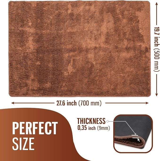 The brown doormat features a plush, absorbent texture with measurements displayed: 27.6 inches wide and 19.7 inches long, with a thickness of 0.35 inches, showcasing a close-up view of the edge.