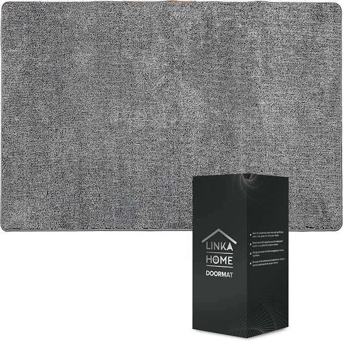 The gray doormat features a textured surface and rounded corners, measuring 23 x 35 inches, with a black box displaying the brand name "Linka Home" and product details in the bottom corner.