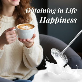A woman in a cozy sweater holds a cup of latte art with a heart design, while a milk frother is shown to the side, suggesting its use for creating frothy beverages.