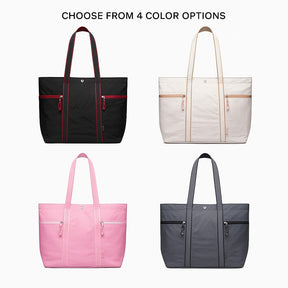 Four large lightweight canvas tote bags are displayed, featuring a black bag with red accents, a cream bag with tan accents, a pink bag with white accents, and a dark gray bag with black accents, each equipped with double top handles and two zippered front pockets.