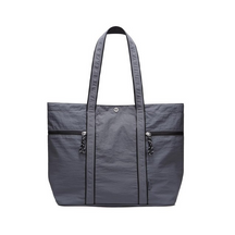 Spacious dark gray canvas tote bag with a zipper and two front pockets, featuring long handles for easy carrying. The bag showcases a simple yet sturdy design, ideal for everyday use.