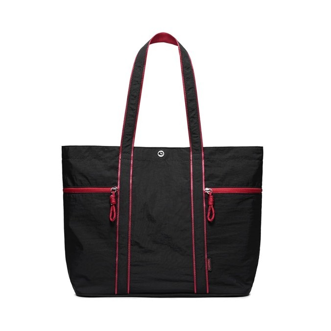 Spacious black canvas tote bag featuring bright red zippers and stitching, dual shoulder straps, and a sturdy design suitable for heavy-duty use. Two front zippered pockets add functionality and style.