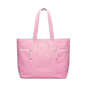 Large pink canvas tote bag featuring two front zippered pockets and sturdy, dual shoulder straps. The design emphasizes a lightweight and durable structure suitable for various uses.