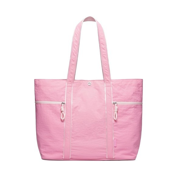 Large pink canvas tote bag featuring two front zippered pockets and sturdy, dual shoulder straps. The design emphasizes a lightweight and durable structure suitable for various uses.