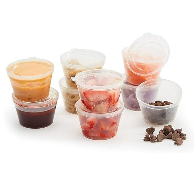 Assorted clear plastic condiment containers with hinged lids, each filled with various foods like sauces, fruits, and chocolate chips, arranged in stacks and groups. The containers are 3 oz. in size and designed for leak-proof storage.