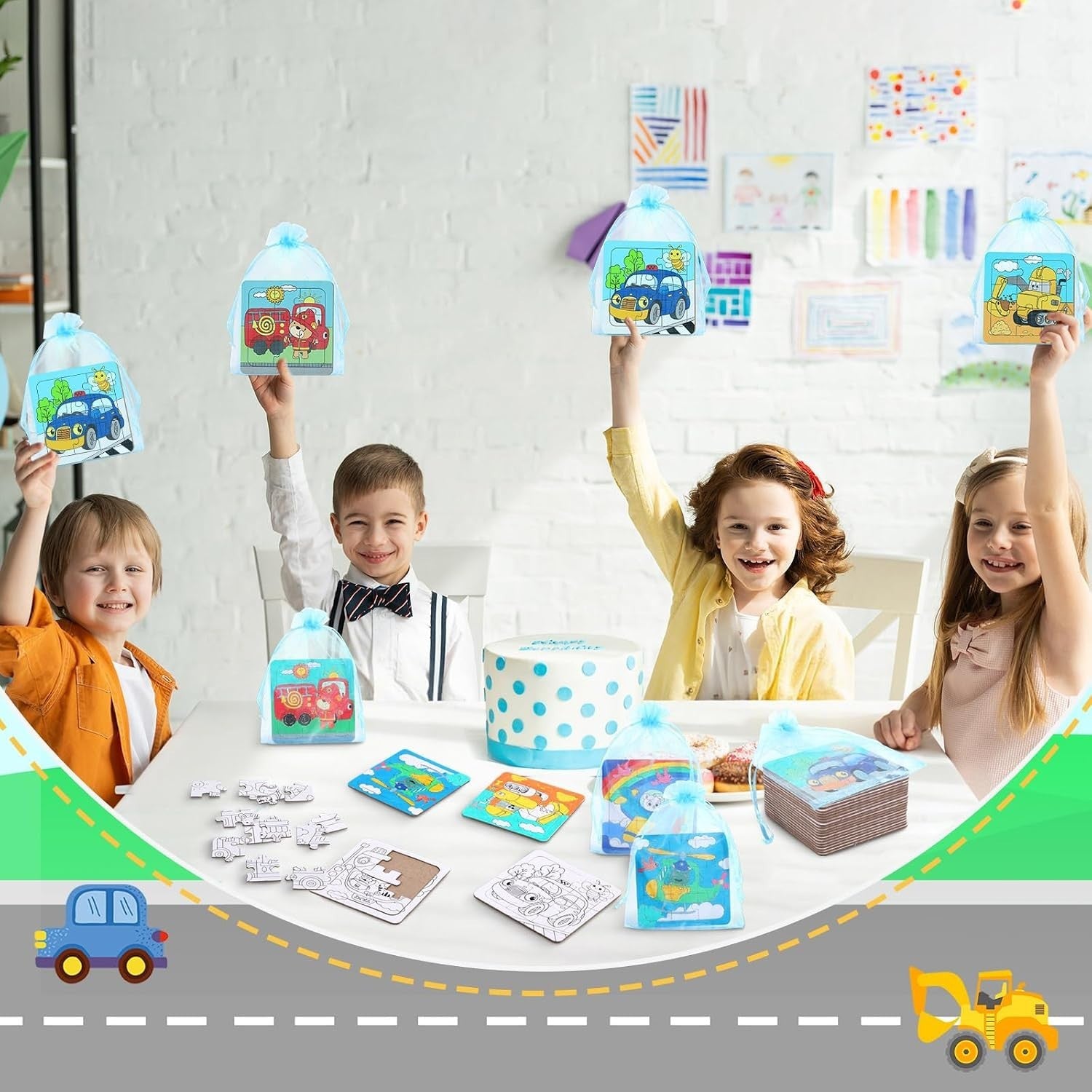 Children smiling and holding up colorful, illustrated transportation-themed puzzles at a table, with partially completed puzzles and a cake with blue polka dots in the foreground. The background features drawings hung on a wall.