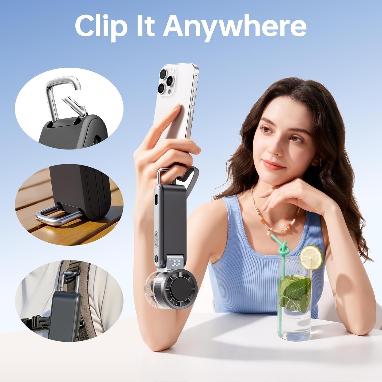 A woman is holding a black handheld turbo fan with a clip attachment, demonstrating its portability while a smartphone rests in her other hand. The background features a blue gradient, and a glass with a straw and lime slice is placed on the table beside her.