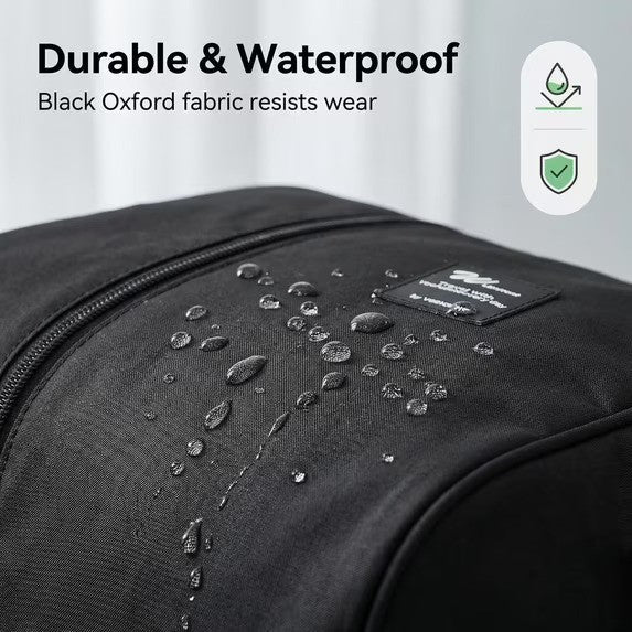 Close-up of the Foldable Weekender Tote Bag highlighting water droplets on the black Oxford fabric, showcasing its durable and waterproof qualities with a tag visible.