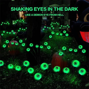 Green LED eyeball lights are arranged in a dark outdoor setting, creating a spooky atmosphere among carved pumpkins and decorative elements. The text above features a Halloween theme, emphasizing the eerie effect of the lights.