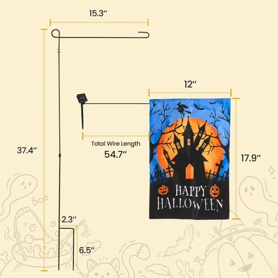 Illustration showing a solar garden flag on a black metal pole with dimensions labeled, featuring a Halloween-themed flag displaying a haunted house, an orange moon, and the text "HAPPY HALLOWEEN." The setup includes a solar panel and wire details for installation.