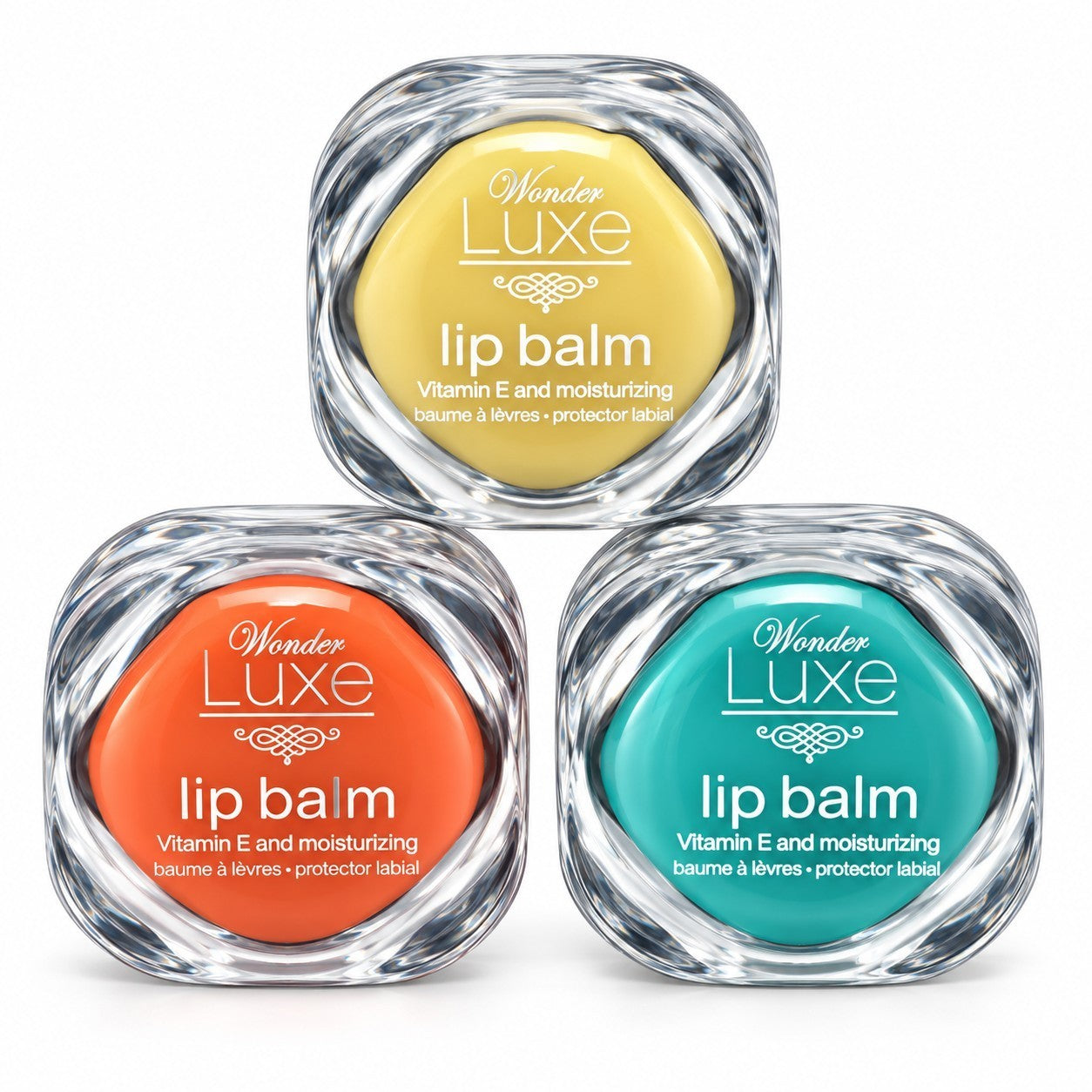 Three assorted flavors of Wonder Luxe Lip Balm in yellow, orange, and teal containers are displayed. Each container features a clear plastic design and text indicating they are moisturizing lip balms enriched with Vitamin E.