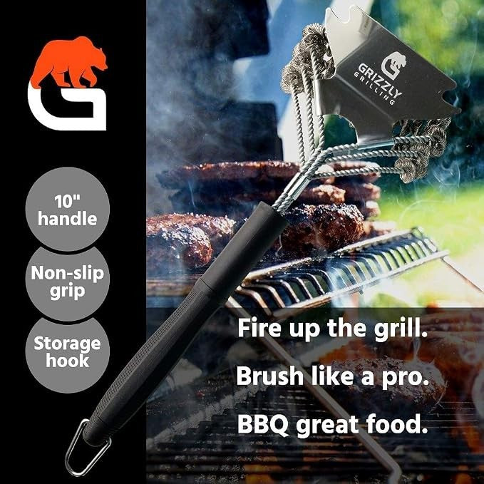 The grill brush features a sturdy 10-inch handle with a non-slip grip, designed with metal bristles and a scraper, set against a background of grilled meat on a barbecue. Text elements describe its functions and storage hook detail.