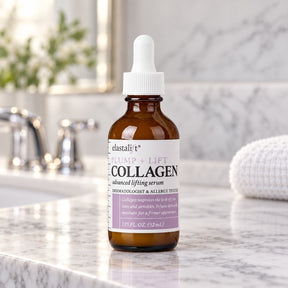 Brown glass bottle of Elastalift Collagen Serum featuring a white dropper lid, labeled with "PLUMP + LIFT COLLAGEN advanced lifting serum" in black and purple text, set against a marble countertop with a soft white towel in the background.