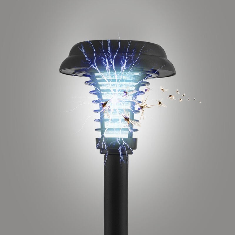 Close-up of a solar-powered bug zapper stake, featuring a cylindrical black base and a blue glowing light with visible electric arcs, illustrating its insect-zapping function, surrounded by flying insects.