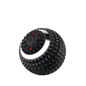 Round, black massage ball featuring textured silicone for grip and three intensity settings, highlighted by illuminated buttons on the top. The silver band around the middle adds a sleek contrast to the overall design.