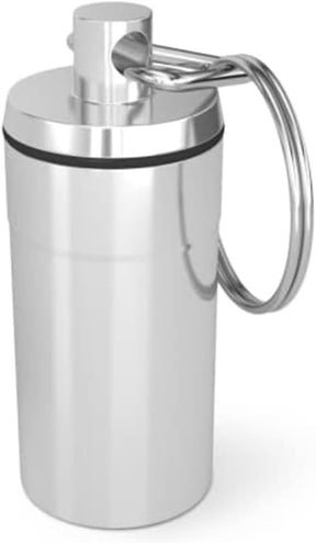 The silver metal capsule features a secure screw-top lid and a keychain attachment for easy portability, designed to hold up to 10 aspirin tablets.