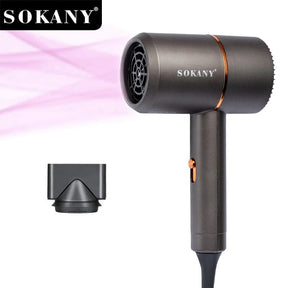 The compact SOKANY SK-2202 Hair Dryer features a sleek dark gray finish with an orange accent, and is accompanied by a concentrator nozzle. A stream of pink airflow is visibly emitted from the dryer, showcasing its functionality.