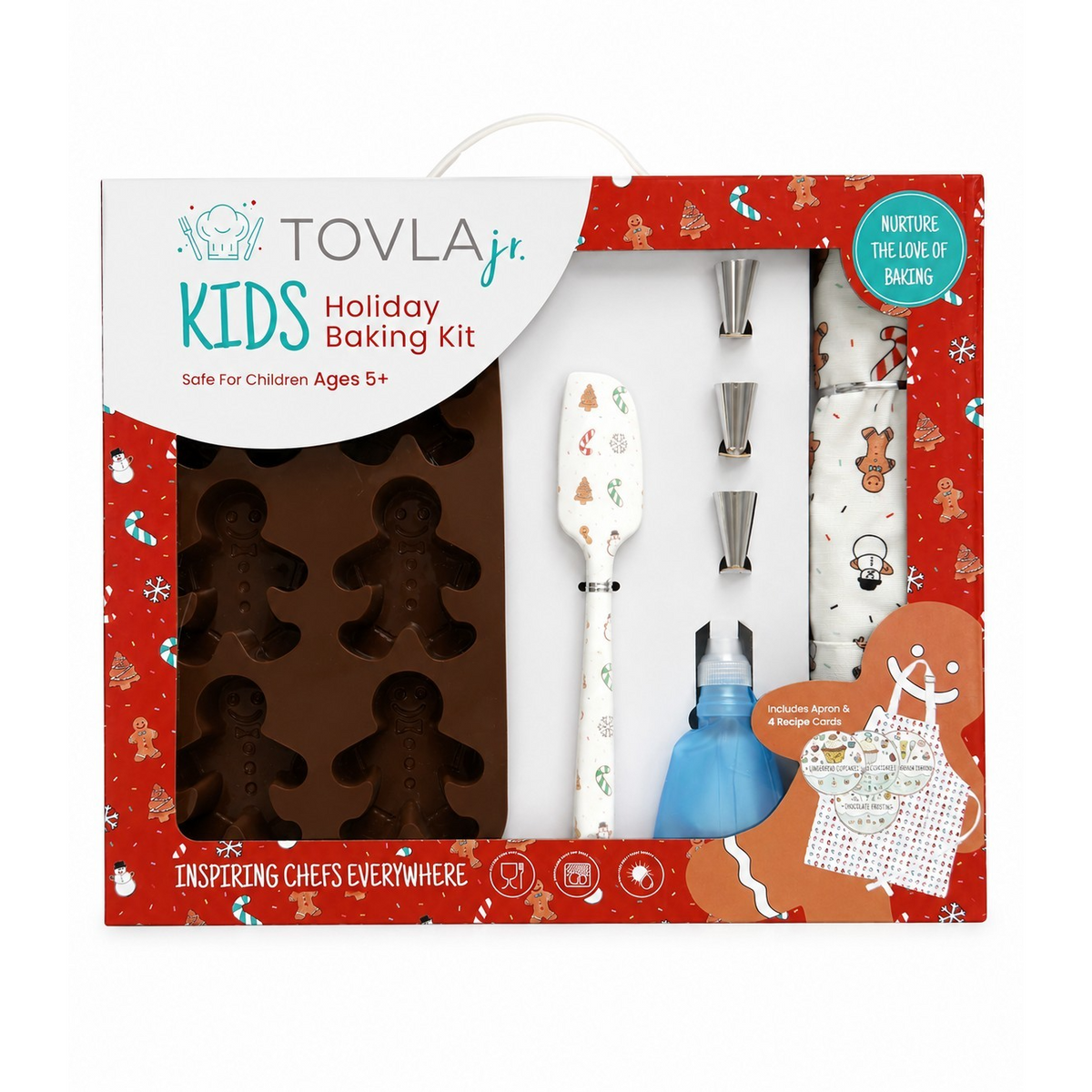 The baking kit features a holiday-themed box in red with festive illustrations and includes a silicone gingerbread cookie mold, a spatula, piping tools, a squeeze bottle, and a printed apron with gingerbread designs. The kit is designed for children ages 5 and up and promotes creative baking during the holiday season.