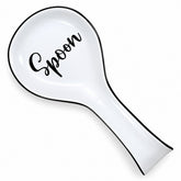 White ceramic spoon rest featuring a black cursive "Spoon" inscription and a sleek black trim, designed to be placed on kitchen counters or stove tops.